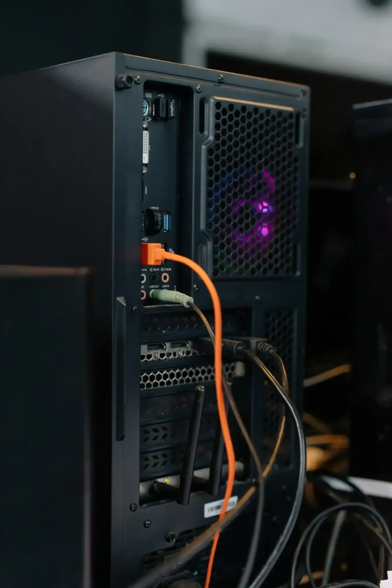 Photo of back of a computer tower with cables coming out of it