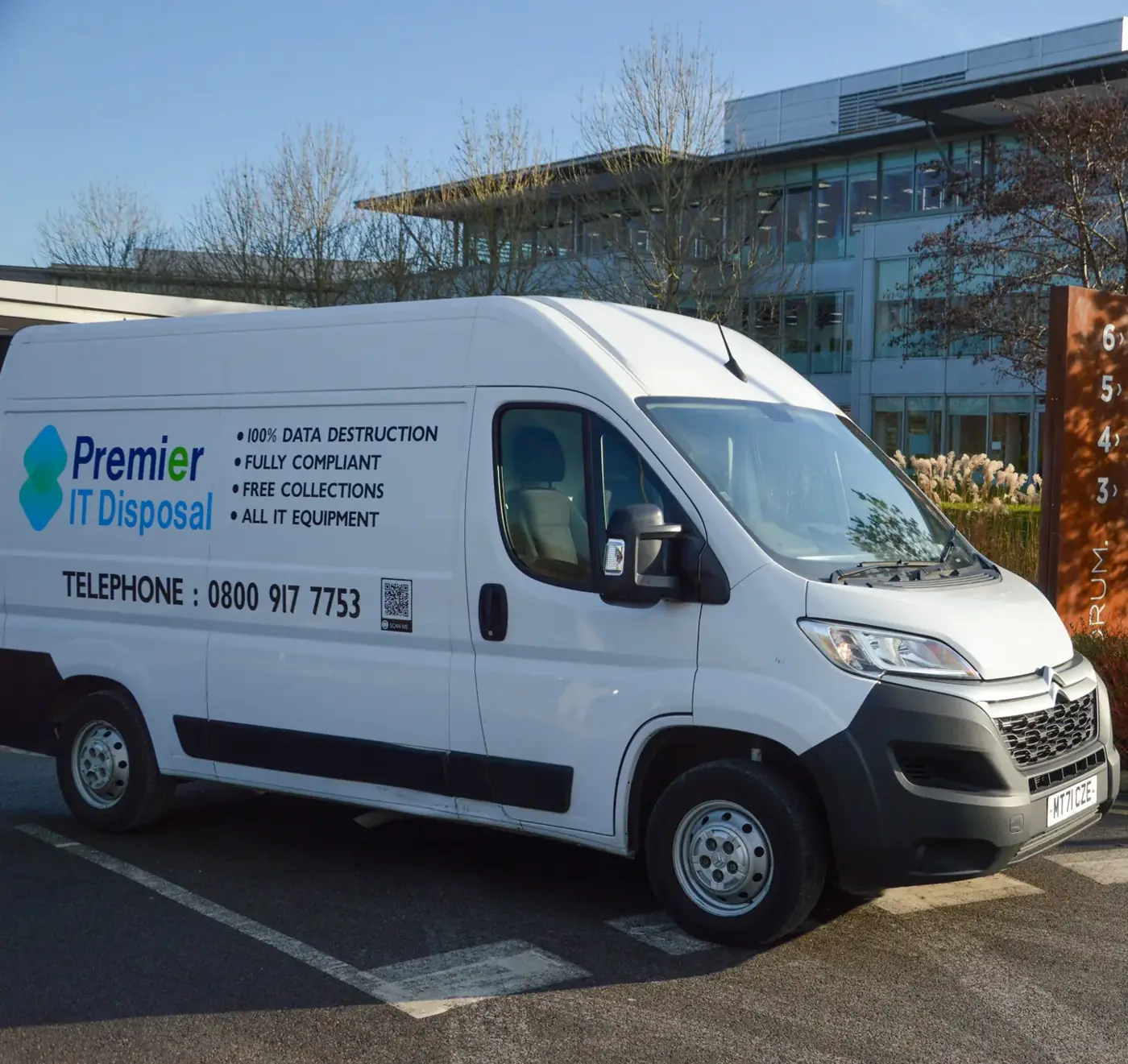 Laptop recycling van in front of building